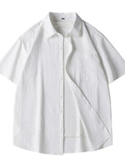 White relaxed fit button-up shirt with short sleeves and chest pocket.