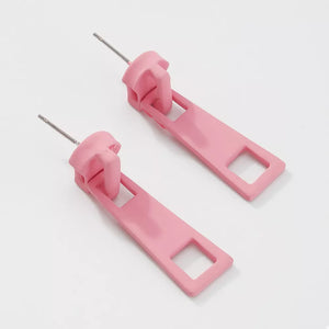 Pink zipper drop earrings with square cutouts and silver posts.