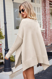 Oversized tan ribbed knit sweater with slit hem and ribbed sleeves.