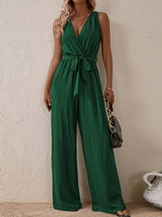 Dark green textured wrap-front wide-leg jumpsuit with tie waist and V-neck