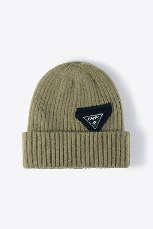 Green ribbed acrylic beanie with a black triangle patch that says HAPPY