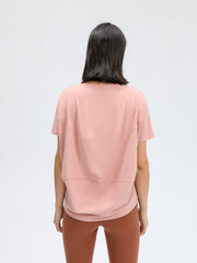 Relaxed fit performance tee in pink with short sleeves and layered detail.