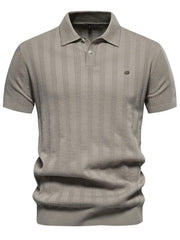 Beige textured ribbed knit polo shirt with short sleeves and a button placket.