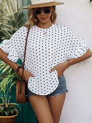 White polka dot blouse with ruffled sleeves and keyhole neckline.