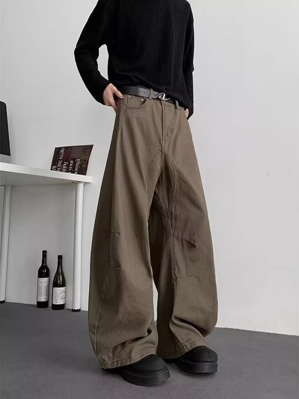 Men's brown baggy sweatpants with pockets and a belted waist.