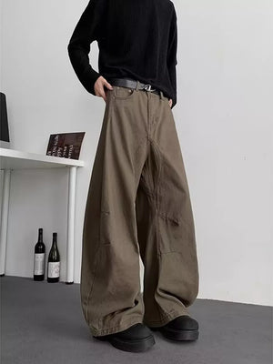 Men's brown baggy sweatpants with pockets and a belted waist.