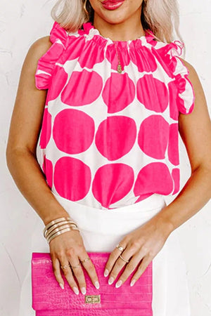 Polka dot frill tank top with ruffled neckline and sleeves.