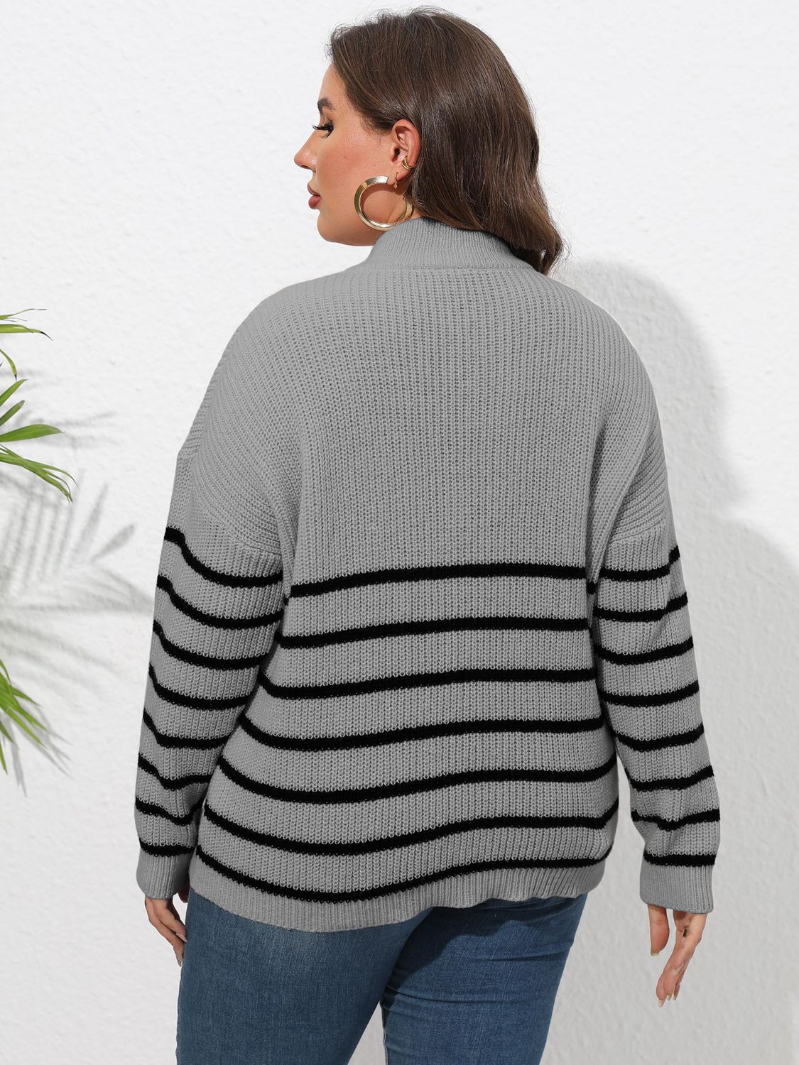 Gray ribbed knit sweater with black stripes and band collar.