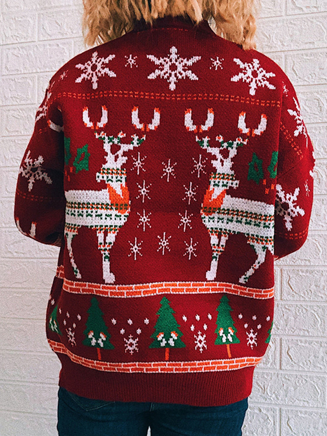 Red acrylic turtleneck sweater with intarsia reindeer and snowflake pattern.