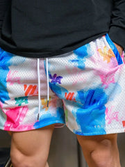 Mesh athletic shorts with abstract floral print in blue, pink, and orange.