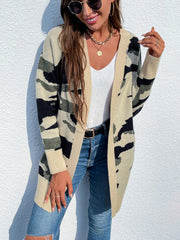 Longline knit cardigan in green camouflage pattern with beige trim and cuffs.