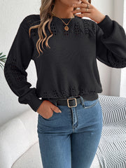 Black acrylic sweater with openwork knit detail on sleeves and neckline.