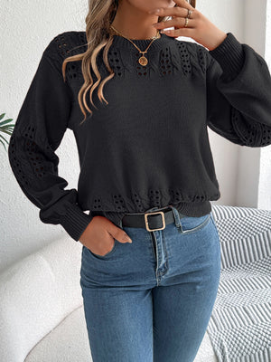 Black acrylic sweater with openwork knit detail on sleeves and neckline.