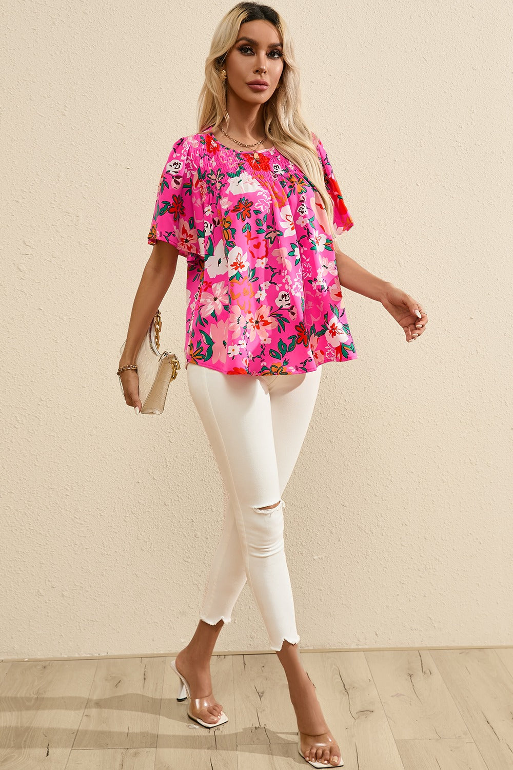 Hot pink floral smocked yoke flutter sleeve blouse with a relaxed fit.