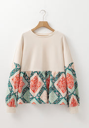 Beige peplum knit top with patchwork paisley print sleeves and hem