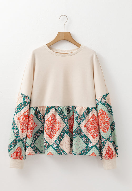 Beige peplum knit top with patchwork paisley print sleeves and hem