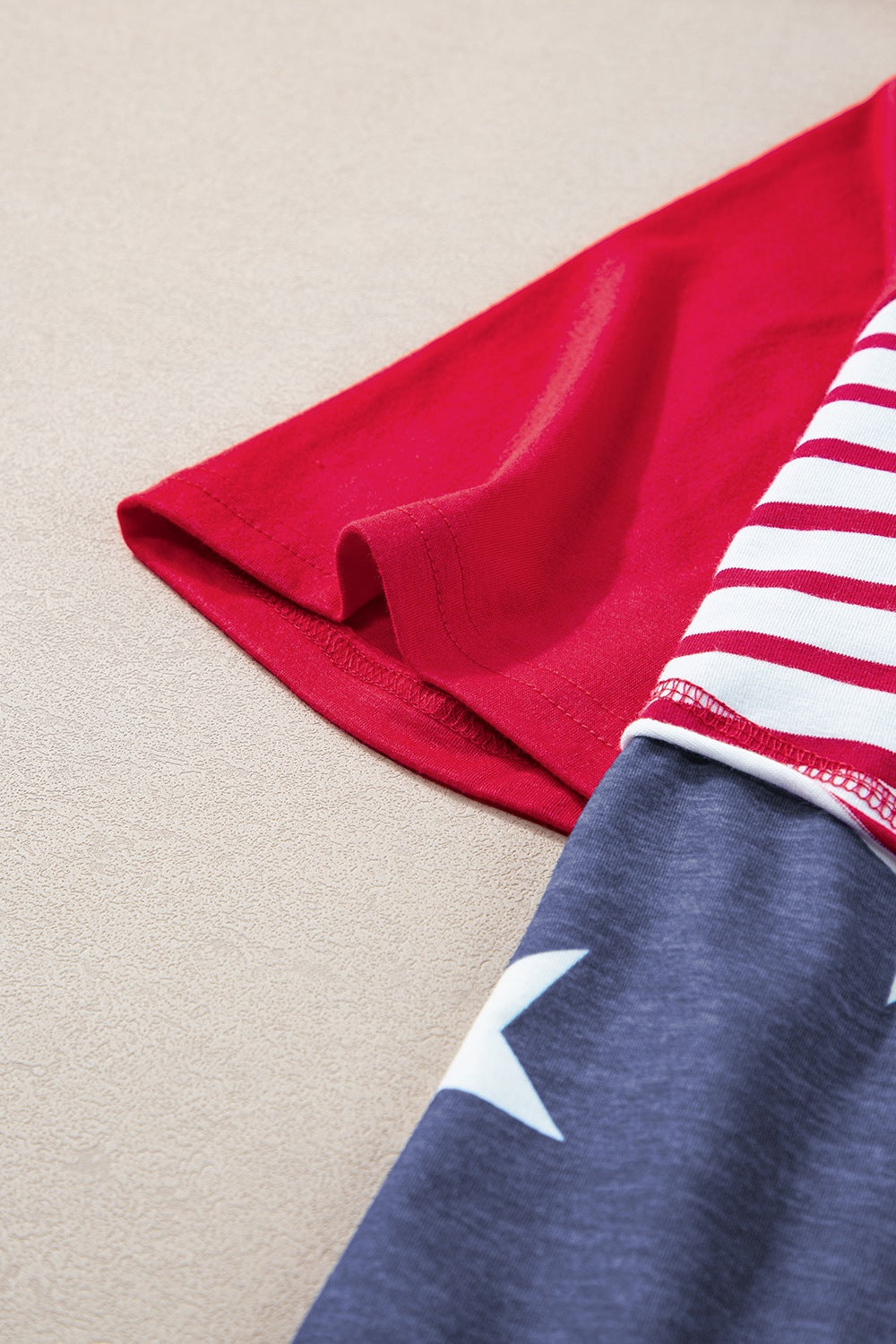 Patriotic raglan hoodie in scarlet with stars and stripes sleeves.