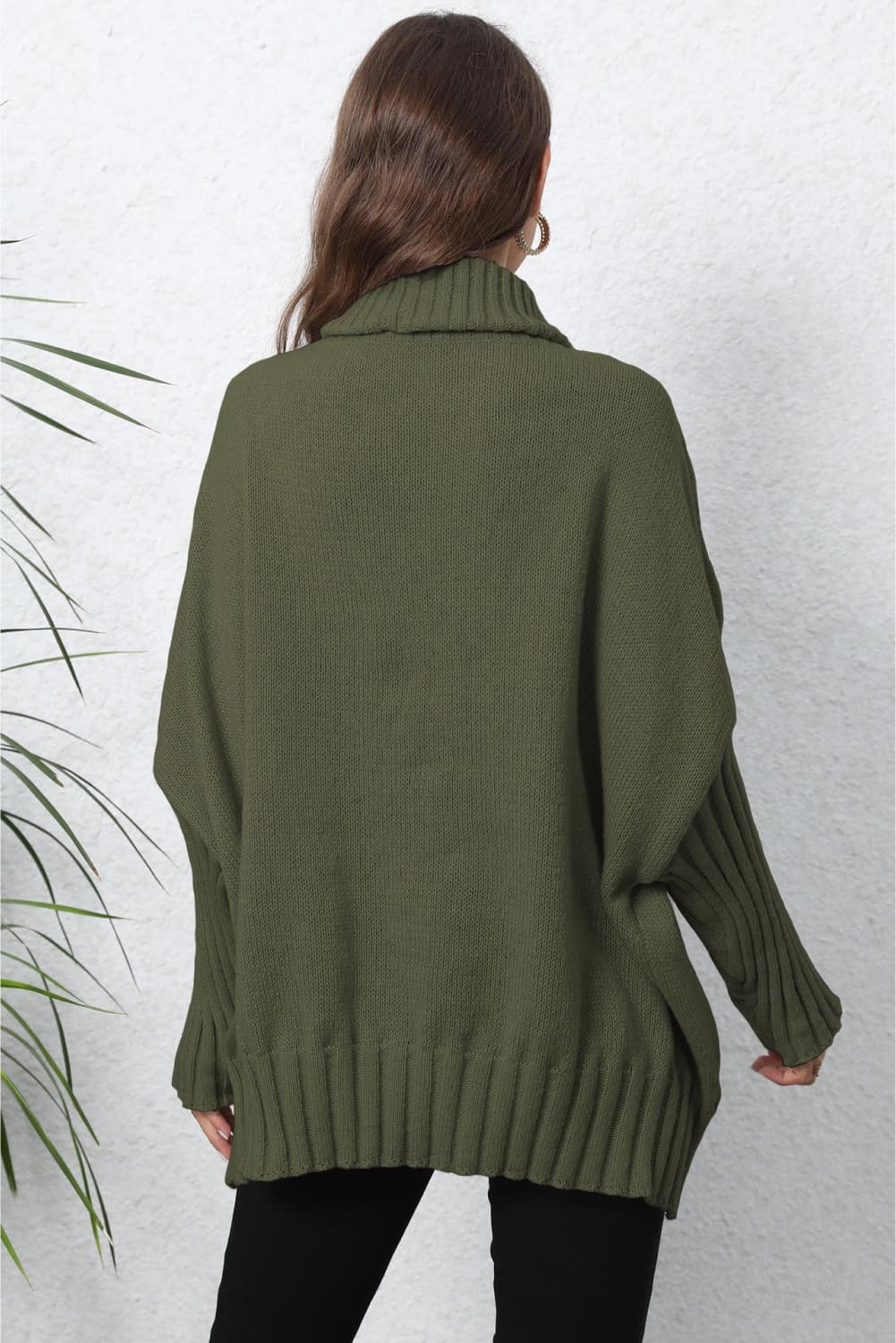 Army green ribbed turtleneck sweater with batwing sleeves and a cozy knit texture.