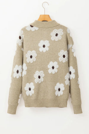 Tan acrylic mock neck sweater with a white floral intarsia pattern.
