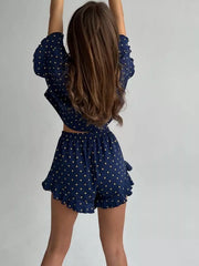 Blue star-print pajama set with ruffled crop top and shorts.