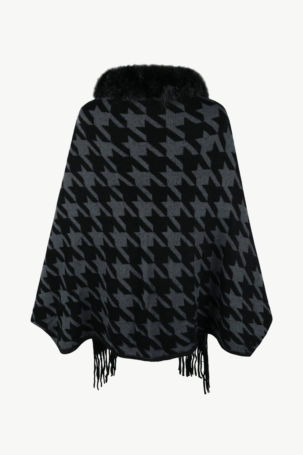 Houndstooth poncho with faux fur collar and fringe detail in black and grey.