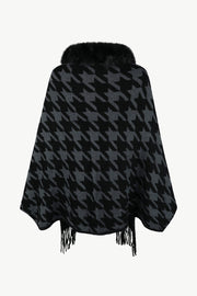 Houndstooth poncho with faux fur collar and fringe detail in black and grey.