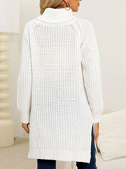 White knit turtleneck sweater with asymmetric hemline and ribbed texture.