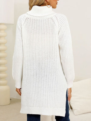 White knit turtleneck sweater with asymmetric hemline and ribbed texture.