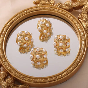 Gold woven pearl grid earrings with a textured finish and cubic shape.