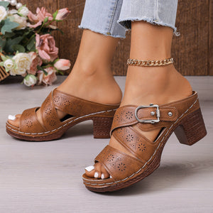 Brown laser-cut criss-cross block heel sandals with buckle detail.