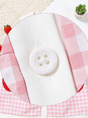 Pink gingham toddler dress with white button detail and fruit appliqué.