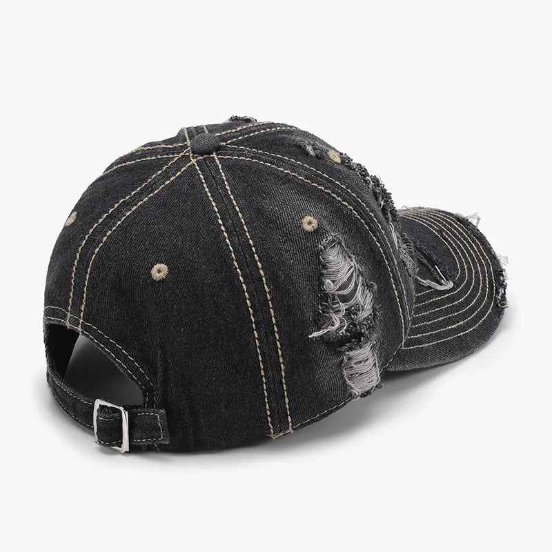 Dark ripped denim baseball cap with distressed details and contrast stitching.