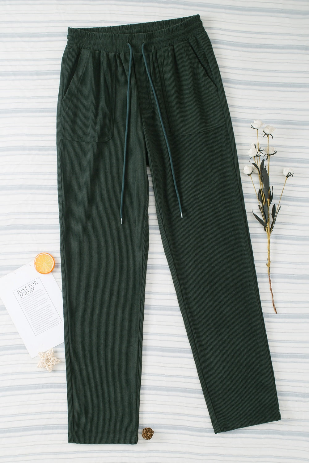 Dark Green corduroy drawstring trousers with slant pockets and a relaxed fit.