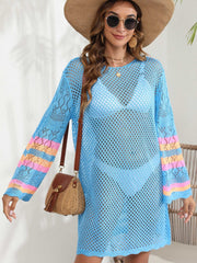 Light blue crochet cover-up with colorful striped sleeves and open knit detail.
