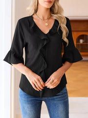 Black maternity shirt with V-neck, cascading ruffles, and 3/4 bell sleeves.