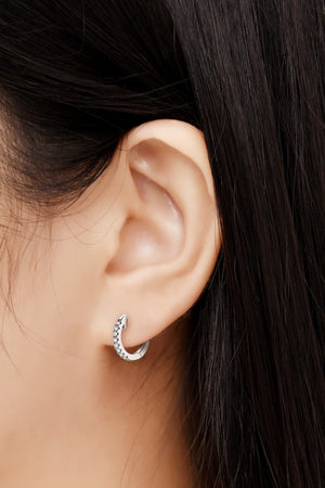 Silver pavé hoop earrings with small clear stones, 18K gold-plated sterling silver.