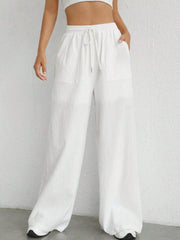 White linen wide-leg drawstring trousers with pockets