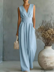 Sky blue sleeveless wide-leg jumpsuit with V-neck, cinched waist, and pockets.