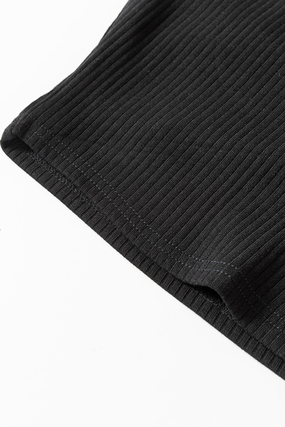 Black ribbed bodysuit detail showing stitching and fabric texture