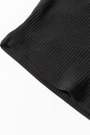 Black ribbed bodysuit detail showing stitching and fabric texture