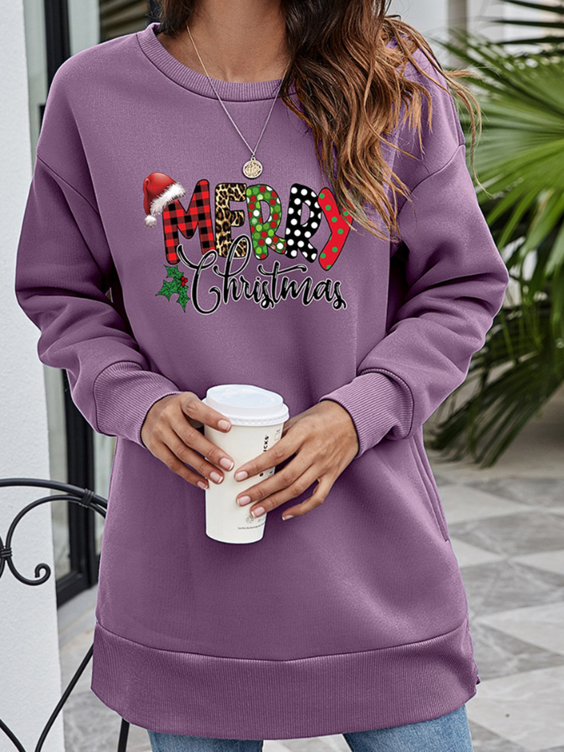Purple tunic sweatshirt with festive "Merry Christmas" graphic and Santa hat detail.
