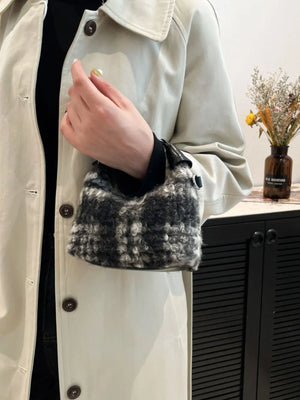 Shearling check mini shoulder bag in black and gray fuzzy material with leather trim.
