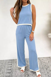 Light blue colorblock two-piece set with white trim, sleeveless crop top and wide-leg pants.