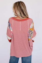 Patchwork stripe raglan tee in deep red with colorful patchwork sleeve details and a relaxed fit.