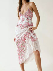Maxi dress with pink floral print, lace trim, and asymmetrical hem.