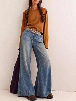 Caramel long sleeve crop top with raw hem, styled with wide leg jeans.