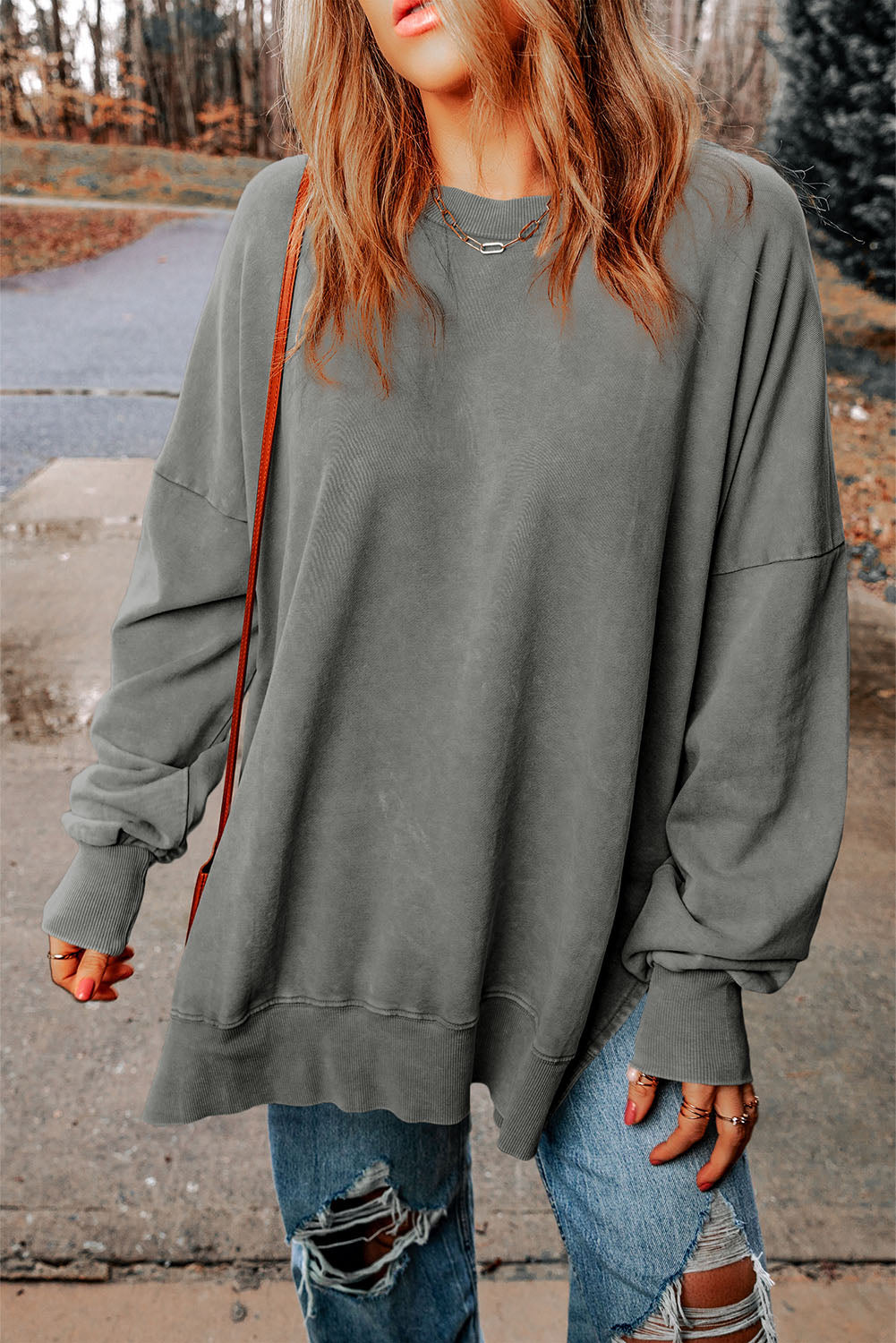 Oversized washed cotton sweatshirt in charcoal with crew neck and side slits.