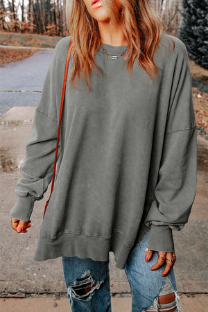 Oversized washed cotton sweatshirt in charcoal with crew neck and side slits.