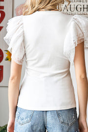White ribbed knit blouse with sheer polka dot ruffle sleeves