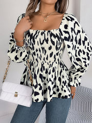 Cream and black leopard print smocked bodice square neck peplum blouse with ruffled cuffs.